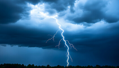 Fototapeta na wymiar Dramatic lightning strike through dark storm clouds above a silhouetted treeline. A powerful image showcasing the raw energy of nature.