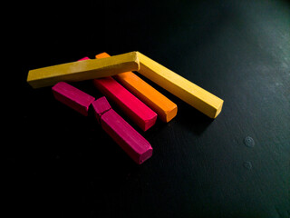 colorful chalk pastels on black background