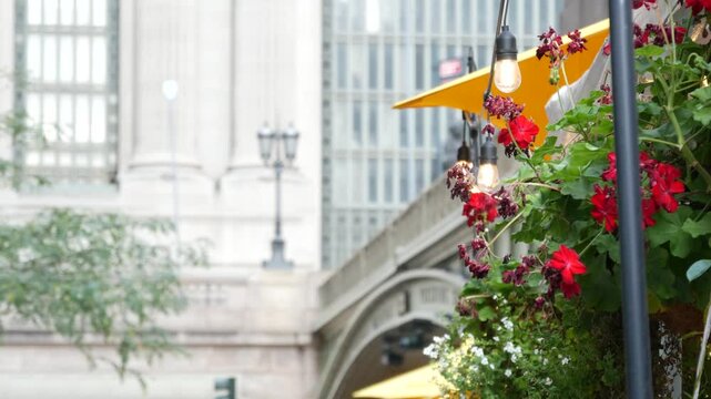 New York City Grand Central Terminal railway station, 42 street. Manhattan Midtown. Bridge on Pershing Square, NYC, USA. American urban scene, United States. Light bulb garland, umbrellas and flowers.