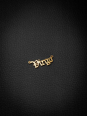 close up gold pendant horoscope with   Virgo  sign   on a black background
