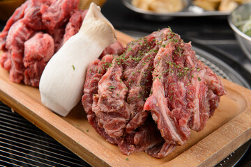 Raw beef and mushrooms on a wooden plate
