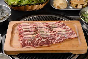 Seasoned ribs on a wooden plate
