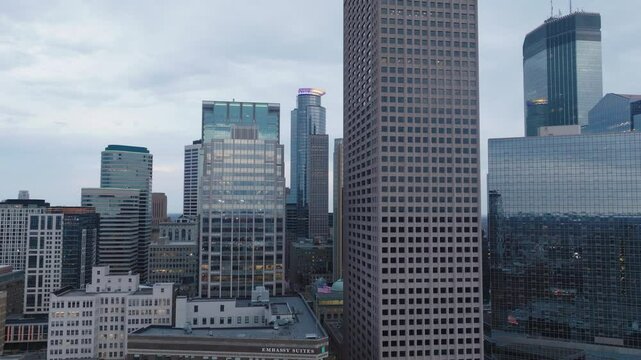 Aerial footage of downtown Minneapolis skyline at dusk with city buildings glowing.