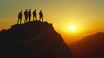 Fototapeta premium Silhouettes of a group climbing a mountain together at sunrise