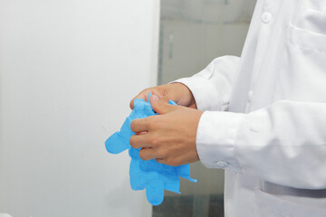 Scientist wearing blue nitrile gloves, readying laboratory equipment for precise scientific research