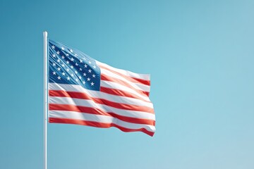Fototapeta premium lone usa flag gently waves against clear blue sky