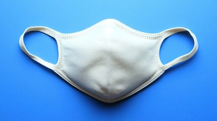 White face mask on blue background