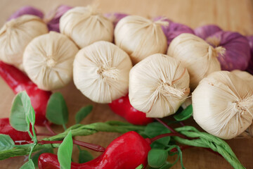 Colorful display of garlic bundles and red peppers at local market
