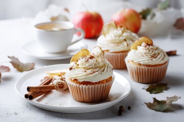 Homemade autumn cupcakes topped with cream cheese dried apples and cinnamon on a white plate Close up with space for text