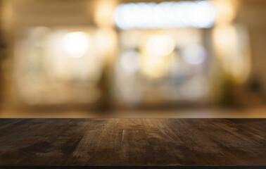 Empty wood table top and blur of restaurant background selective focus product display