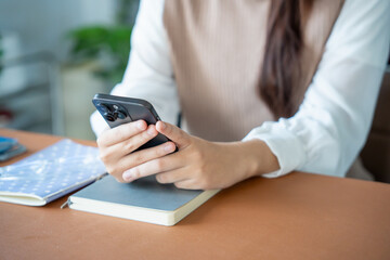 Student asian woman lying use smart phone in dorm room college mobile addict spending time checking news technology e-commerce.