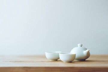 serene chinese tea ceremony setup with porcelain cups and teapot on smooth wooden surface