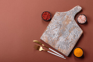 Empty wooden cutting board on a monochrome brown background