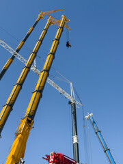 Construction cranes. View from below. Crane used to construct palaces, houses or buildings. Construction site. General contest