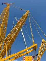 Construction cranes. View from below. Crane used to construct palaces, houses or buildings. Construction site. General contest