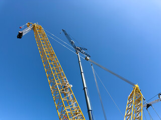 Construction cranes. View from below. Crane used to construct palaces, houses or buildings. Construction site. General contest