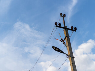 A telephone pole with a street light on top of it