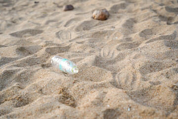 Plastic bottle litter on sandy beach environmental pollution waste management nature conservation outdoor summer careless discarded