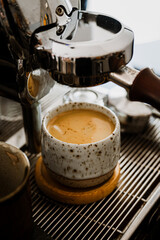 Espresso pouring from coffee machine at cafe,Brewing the espresso coffee from the machine warm tone