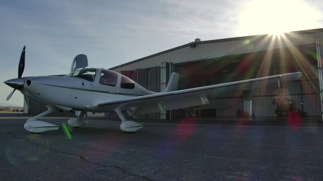 Cirrus SR22 Propeller Airplane Outside Hangar while Opening Doors