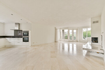 Spacious and bright modern interior featuring sleek cabinetry, serene colors, and minimalist aesthetics that enhance natural light and open space.