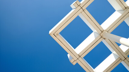Symmetrical architecture roof minimalist grid pattern against deep blue sky with copy space background