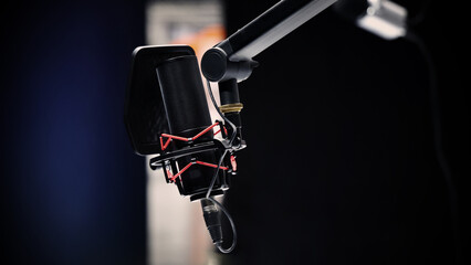 Microphone in studio. Professional studio microphone with a pop filter is suspended boom arm and...