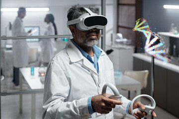 Scientist wearing VR headset is conducting experiment in laboratory, interacting with digital model of DNA Helix. Two colleagues engaged in background activities blurred by depth of field