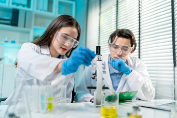 Fototapeta premium Asian male and female scientist work together in the research laboratory.