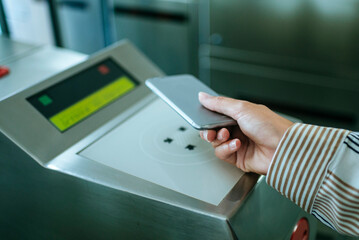 Businesswoman using smartphone to access public transport