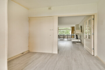 Spacious indoor area featuring a clean, modern aesthetic with neutral tones and natural light streaming through large windows.