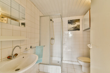 A sleek and modern bathroom featuring a shower, sink, and toilet, designed with minimalistic white...