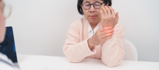 Elderly Patient Woman wrist pain and Consulting doctor. muscle ache from Carpal Tunnel Syndrome, De...