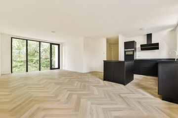 A sleek and spacious kitchen featuring minimalist design with elegant cabinetry, natural light flowing in, and a contemporary feel throughout the space.