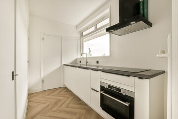 Stylish modern kitchen featuring sleek cabinetry, an integrated oven, and a minimalist design with...