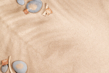 A tropical summer background featuring soft beach sand with delicate palm leaf shadows