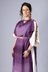 A high-status Roman woman wearing a white tunic with a purple silk stola over the top. She had...