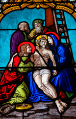 Stained glass (19th century) of The Way of the Cross. Thirteenth station: Jesus' body is taken down...