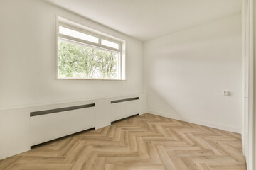 A bright and airy modern interior featuring a large window, minimalist design, light wooden flooring, and white walls that enhance the feeling of spaciousness.