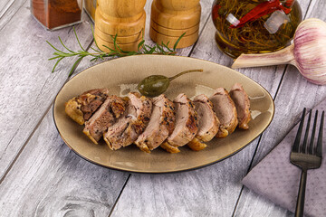 Roasted duck breast slices in the plate