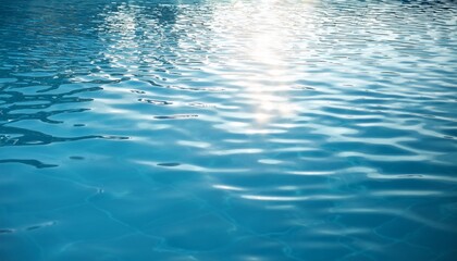 Calm, clear blue water with gentle ripples reflecting sunlight on the surface.