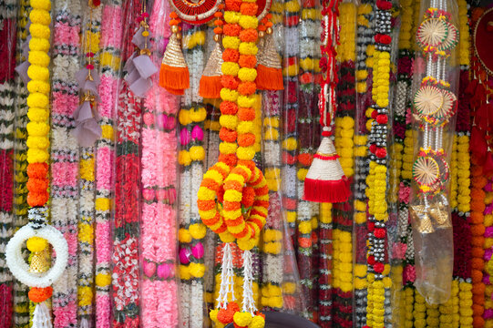 Flower garland on a market stall in India, offering for hindu temple or traditonal indian wedding ceremony, hinduism religion