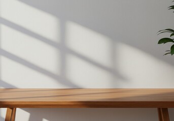 Wooden table against white wall with window shadow and plant decoration