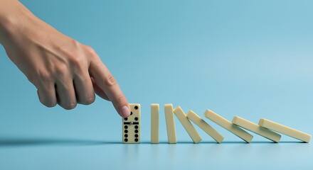 Hand Pushing Domino Effect on Blue Background