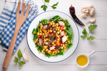 Salpicon de pulpo. Octopus salad with chickpeas, arugula and vegetables. Top view table.