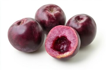 Obraz premium Fresh, ripe plums arranged artistically on a white background, showcasing their vibrant color