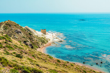Punta Bianca, near Agrigento in Sicily Italy. Beach with ruins of an stone house on white cliffs.