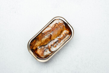 Canned seafood displayed on a white surface ready for culinary use