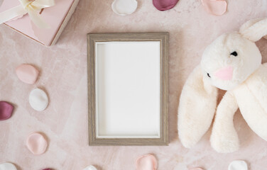 Baby shower invitation with a blank photo frame and soft decorations
