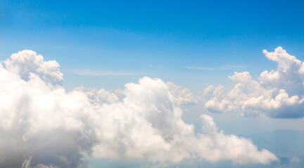 Image of white beautiful clouds above blue sky style of realistic atmospheres, aerial view